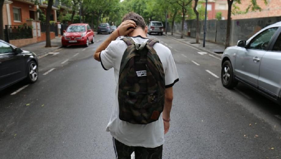 Teenage boy walking down street credit Jesus Rodriguez on Unsplash