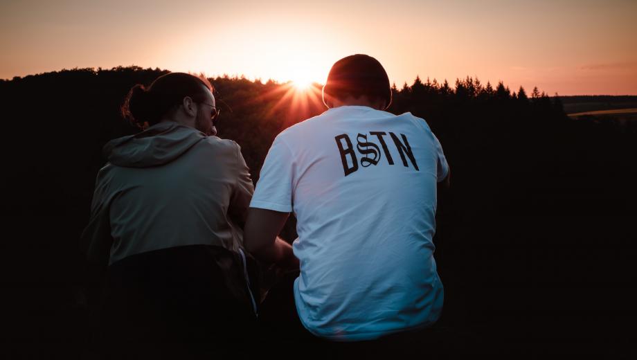 Men talking and watching sunset photo credit Stefan Gall on Unsplash