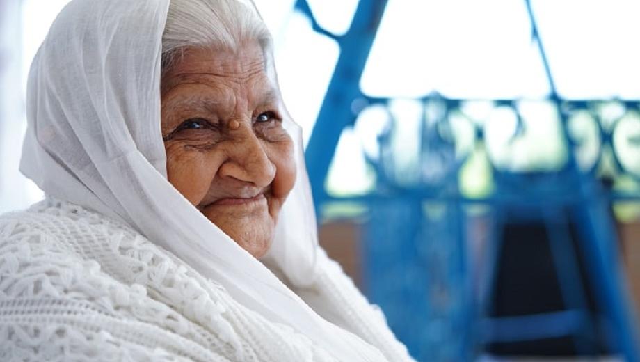 older woman in white sari smiling photo credit Pranav Kumar Jain on unsplash
